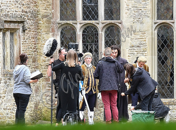 Aidan Turner and crew members in front of Chavenage House