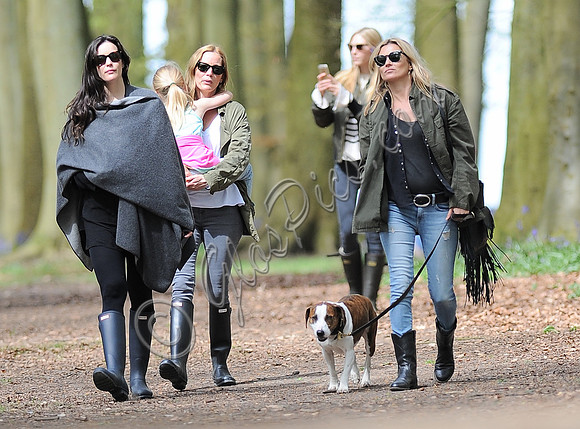 Supermodel Kate Moss wearing military style jacket, skinny jeans and cowboy boots takes a walk with her dog Archie and Liv Tyler who looked cool wearing a poncho teamed with Hunter wellies