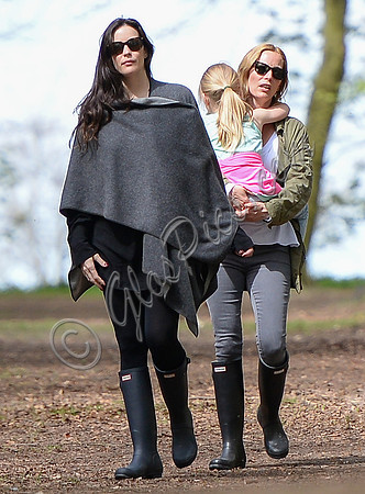 Actress Liv Tyler wearing poncho, skinny jeans and Hunter wellies walking in Oxfordshire