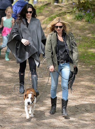 Supermodel Kate Moss wearing military style jacket, skinny jeans and cowboy boots takes a walk with her dog Archie and Liv Tyler who looked cool wearing a poncho teamed with Hunter wellies