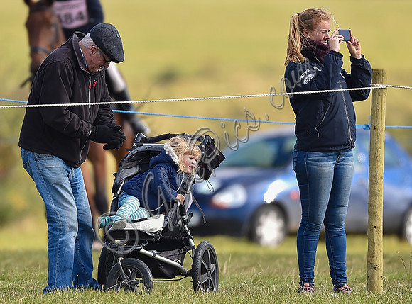 Mia Tindall, groom and family friend watch from outside the arena