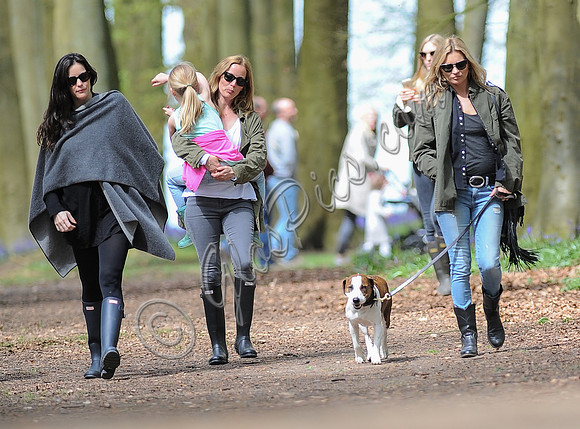 Supermodel Kate Moss wearing military style jacket, skinny jeans and cowboy boots takes a walk with her dog Archie and Liv Tyler who looked cool wearing a poncho teamed with Hunter wellies