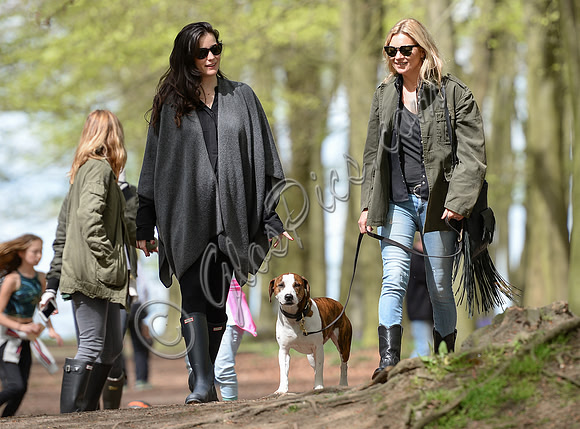 Supermodel Kate Moss wearing military style jacket, skinny jeans and cowboy boots takes a walk with her dog Archie and Liv Tyler who looked cool wearing a poncho teamed with Hunter wellies